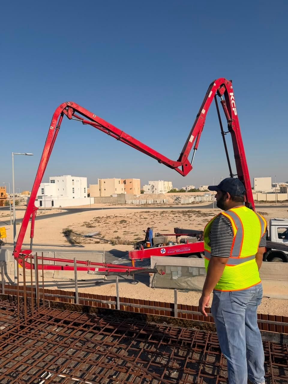 Concrete pump boom deployed at a Fareeq Al Suroor site